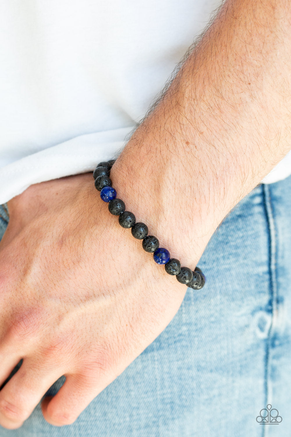 Enlivened - Blue Item #U43 An earthy collection of black lava stones and glassy blue stones are threaded along a stretchy band around the wrist for a seasonal look. All Paparazzi Accessories are lead free and nickel free!  Sold as one individual bracelet.