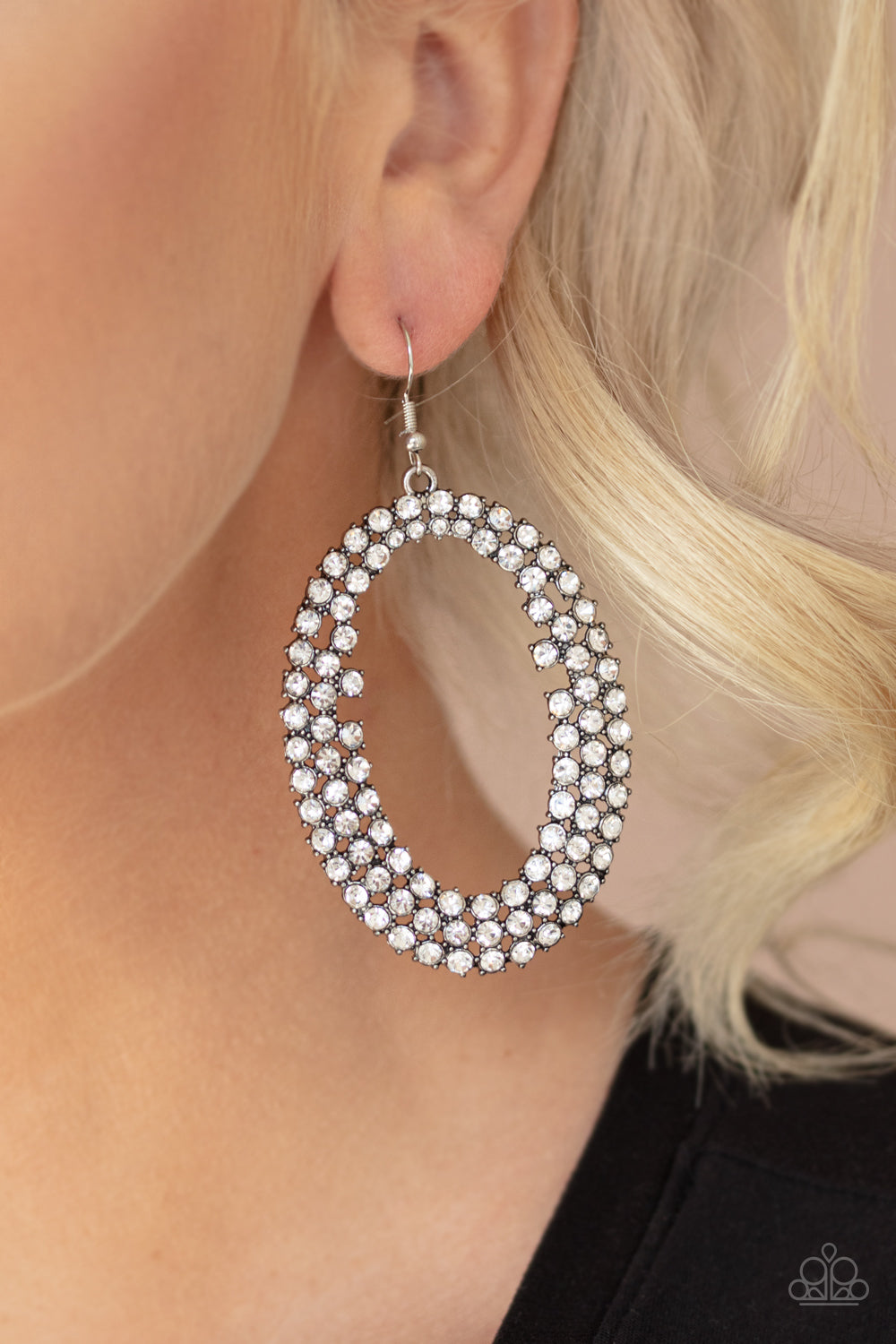 Radical Razzle White Rhinestone Earring - Paparazzi Accessories Item #E407 Row after row of glittery white rhinestones encircle into an oversized hoop, creating a gritty glamorous look. Earring attaches to a standard fishhook fitting. All Paparazzi Accessories are lead free and nickel free!  Sold as one pair of earrings.
