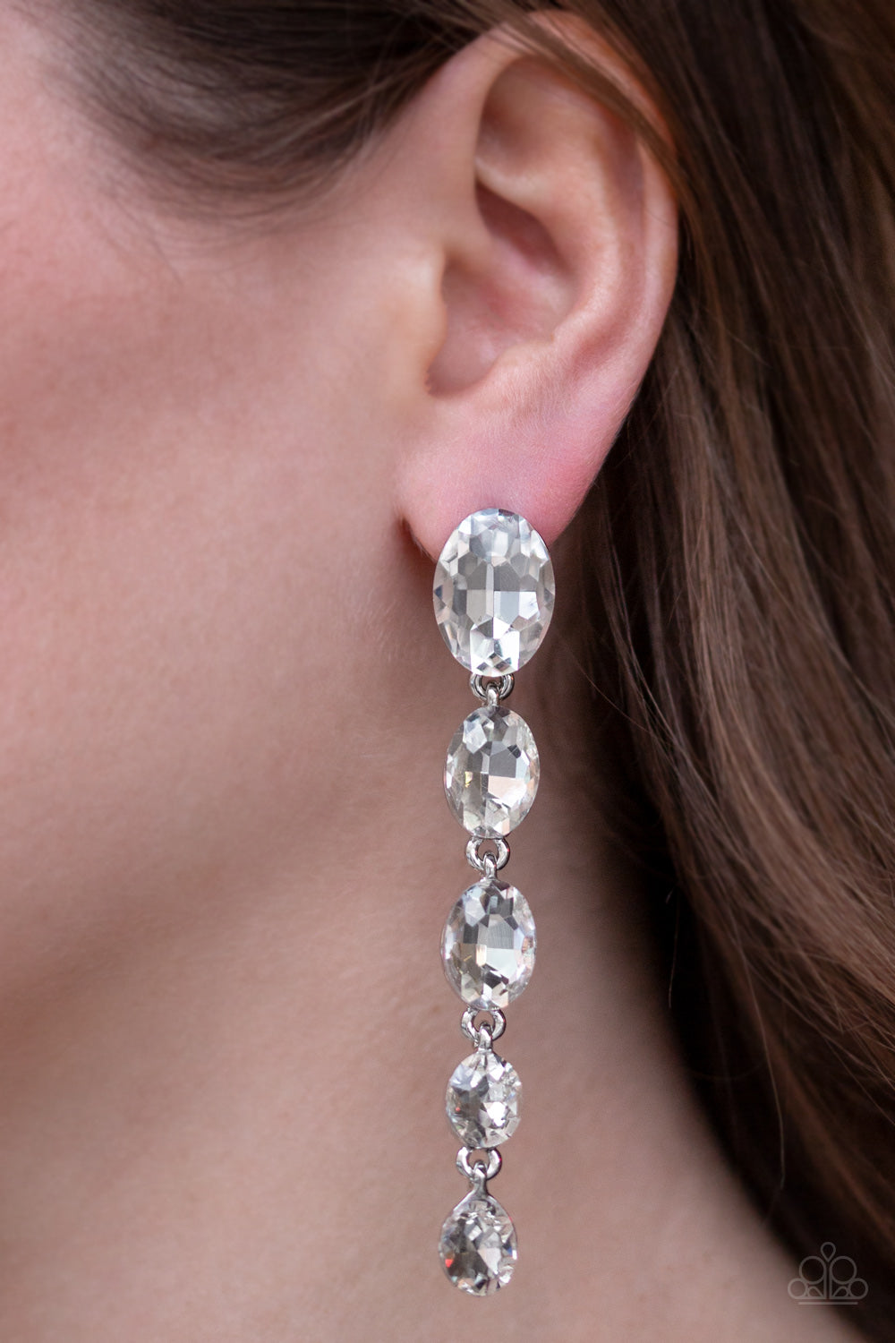 Red Carpet Radiance White Rhinestone Post Earring - Paparazzi Accessories  Gradually decreasing in size, glittery white gems trickle from the ear in a glamorous fashion. Earring attaches to a standard post fitting.  Sold as one pair of post earrings.