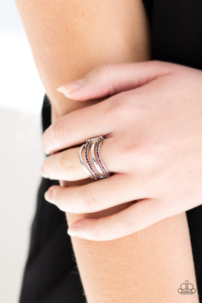 Pageant Wave - Purple Item #P4RE-PRXX-118XX Glistening silver and purple rhinestone encrusted bars wave across the finger, coalescing into an airy band. Features a stretchy band for a flexible fit.  Sold as one individual ring.