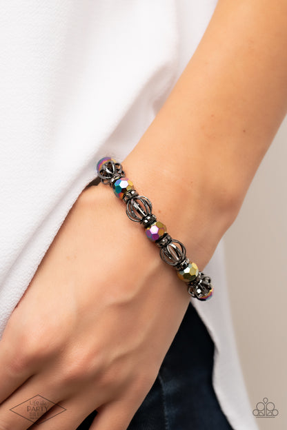 Metro Squad Multi Bracelet - Paparazzi Accessories  A collection of airy gunmetal beads, faceted rainbow metallic beads, and hematite rhinestone encrusted rings are threaded along a stretchy band around the wrist for a glamorous look.  Sold as one individual bracelet.  This Fan Favorite is back in the spotlight at the request of our 2021 Life of the Party member with Black Diamond Access, Ronda N.