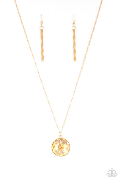 Dauntless Diva Gold Necklace - Paparazzi Accessories  An oversized golden gem swings from the bottom of a lengthened gold chain for a dramatic look. Features an adjustable clasp closure.  All Paparazzi Accessories are lead free and nickel free!  Sold as one individual necklace. Includes one pair of matching earrings.