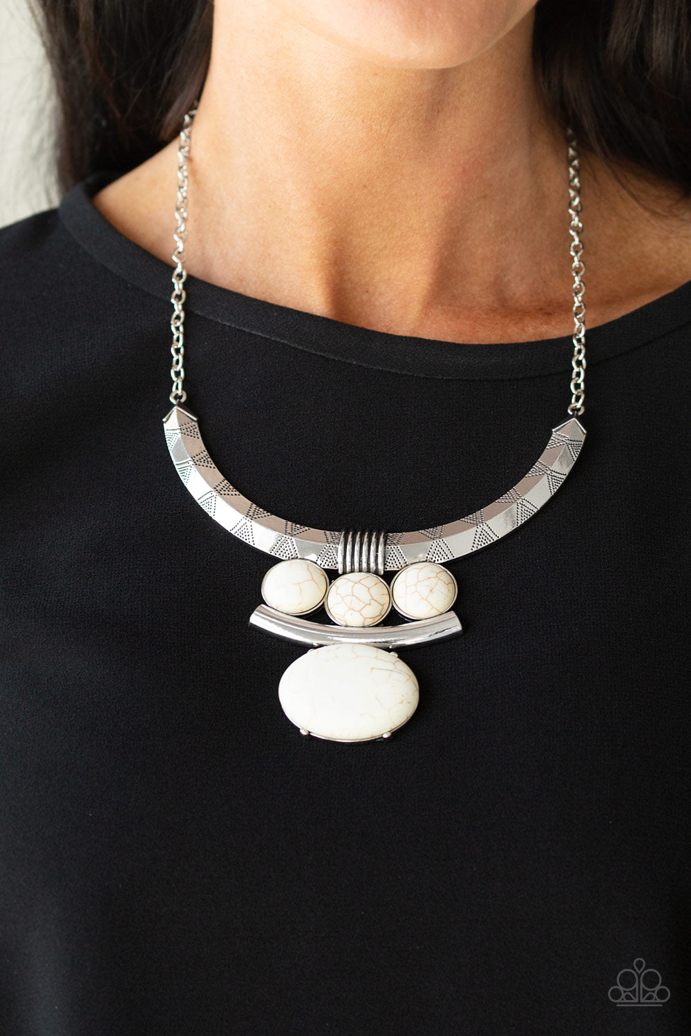 Commander In CHIEFETTE White Necklace - Paparazzi Accessories  Oversized white stone accents alternate with mismatched silver frames, coalescing into a dramatic tribal inspired pendant below the collar. Features an adjustable clasp closure.  All Paparazzi Accessories are lead free and nickel free!  Sold as one individual necklace. Includes one pair of matching earrings.