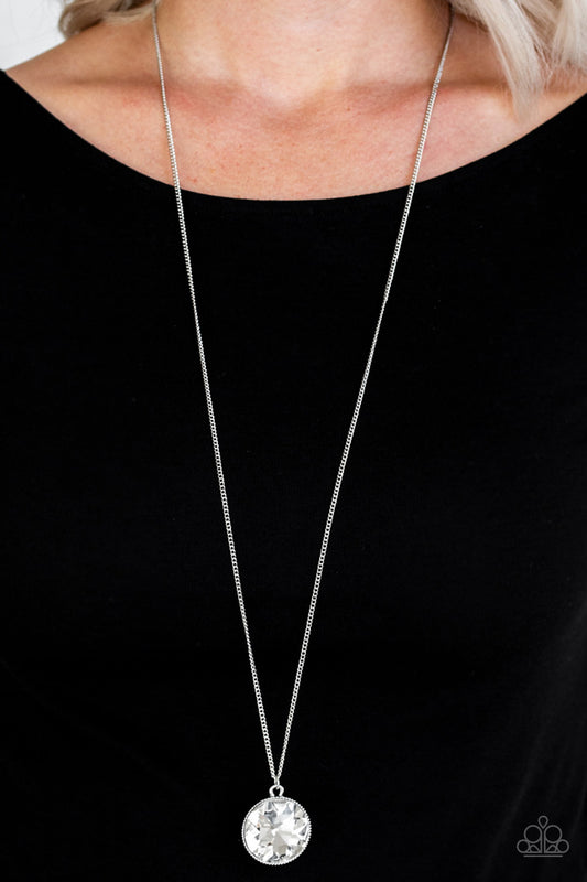 Dauntless Diva White Necklace - Paparazzi Accessories  An oversized white gem swings from the bottom of a lengthened silver chain for a dramatic look. Features an adjustable clasp closure.  All Paparazzi Accessories are lead free and nickel free!  Sold as one individual necklace. Includes one pair of matching earrings.
