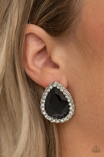 Dare To Shine Black Earring - Paparazzi Accessories  Encrusted in a ring of glittery white rhinestones, an overly dramatic black teardrop gem is pressed into a textured silver frame for a glamorous look. Earring attaches to a standard post fitting.  All Paparazzi Accessories are lead free and nickel free!  Sold as one pair of post earrings.