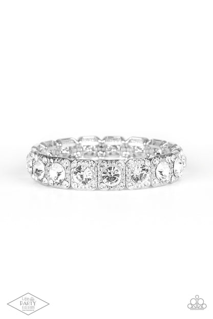 Blinged Out White Bracelet - Paparazzi Accessories  Featuring oversized white rhinestone centers, studded silver frames radiating in glassy white rhinestones are threaded along a stretchy band around the wrist for a glamorous fashion.  Sold as one individual bracelet. This Fan Favorite is back in the spotlight at the request of our 2021 Life of the Party member with Black Diamond Access, Leigh B.