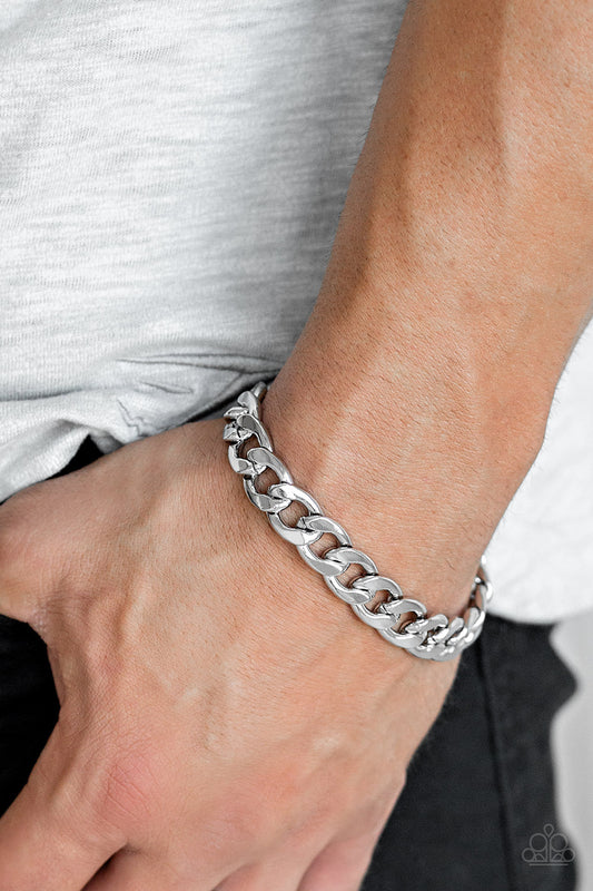 Leader Board Silver Urban Bracelet - Paparazzi Accessories. A thick strand of silver curb link chain is wrapped around the wrist for a classic look. Features an adjustable clasp closure.  All Paparazzi Accessories are lead free and nickel free!  Sold as one individual bracelet.