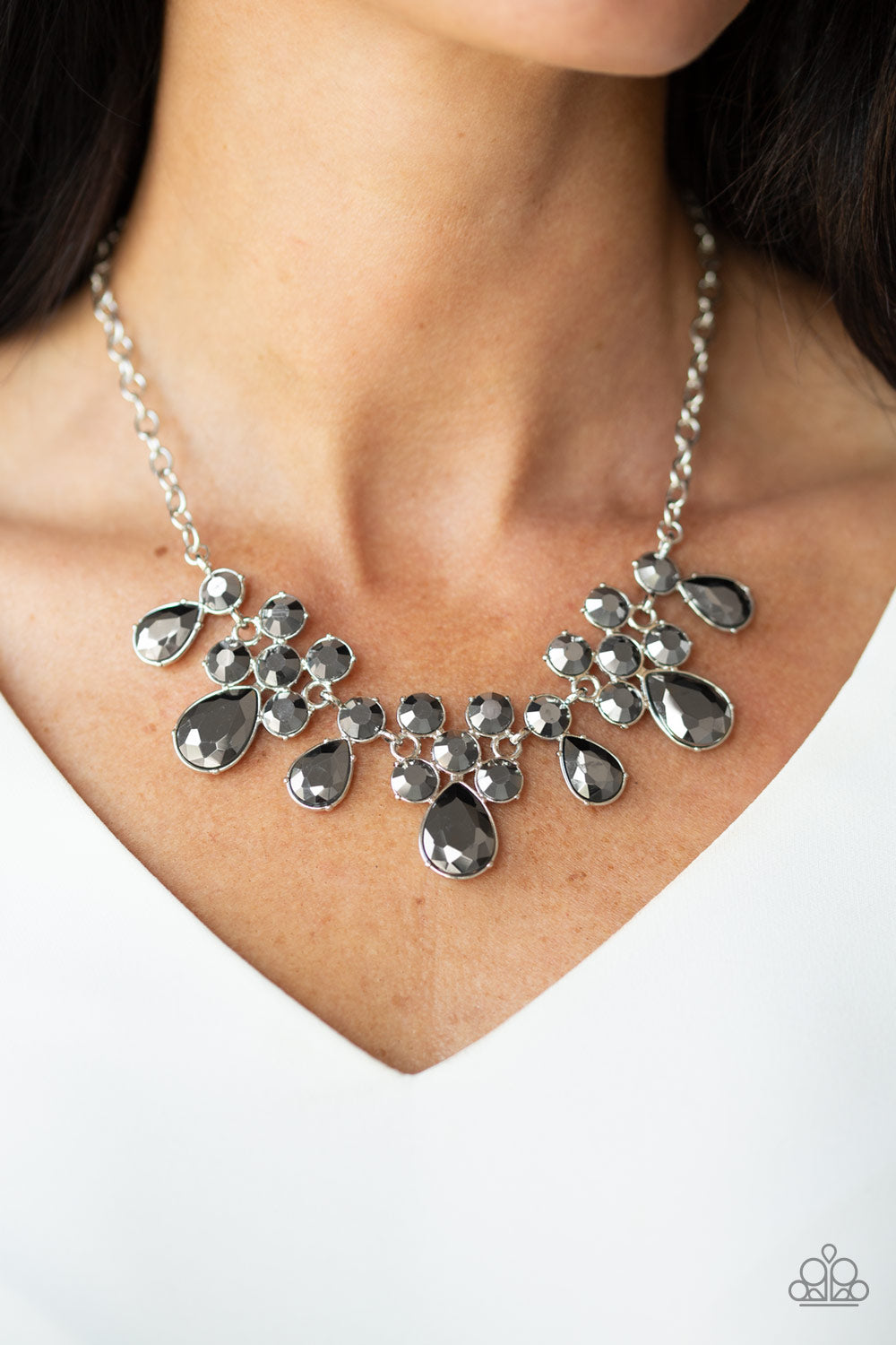 Debutante Drama Silver Necklace - Paparazzi Accessories  A collection of round and teardrop hematite rhinestones coalesce into dazzling frames as they link below the collar, creating a glamorous fringe. Features an adjustable clasp closure. All Paparazzi Accessories are lead free and nickel free!  Sold as one individual necklace. Includes one pair of matching earrings.