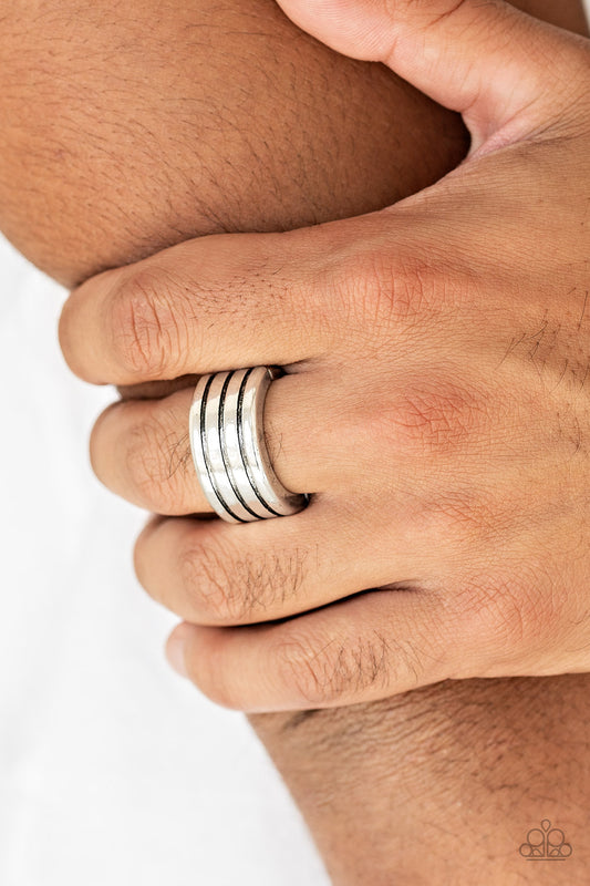 Zip Line Silver Urban Ring - Paparazzi Accessories  Row after row of horizontal lines are engraved across the front of a thick silver band for a rustic look. Features a stretchy band for a flexible fit.  Sold as one individual ring.
