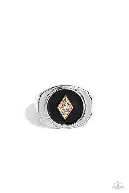 Alumni Black Urban Ring - Paparazzi Accessories   A solitaire white rhinestone is pressed into the center of a gold diamond-shaped frame that sits atop a painted black backdrop. Features a stretchy band for a flexible fit.  Sold as one individual ring.
