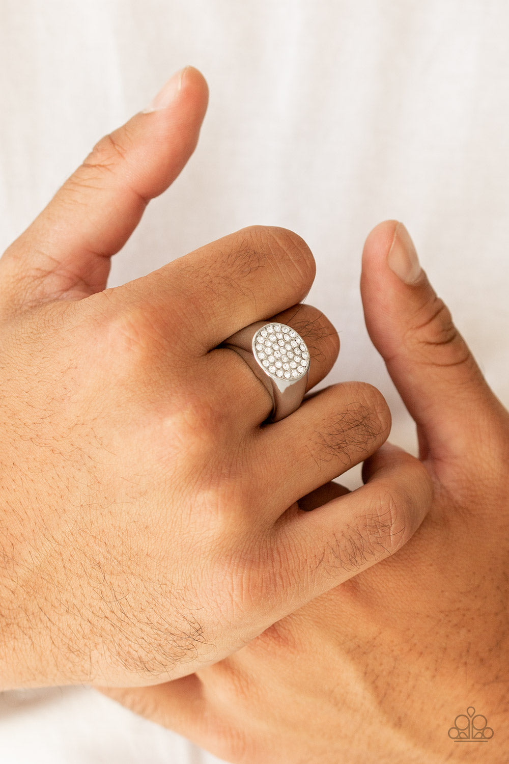 Conquest White Urban Ring - Paparazzi Accessories  Glassy white rhinestones are encrusted atop a flattened circular frame for a statement look. Features a stretchy band for a flexible fit.  All Paparazzi Accessories are lead free and nickel free!  Sold as one individual ring.