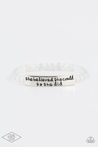 So She Did White Bracelet - Paparazzi Accessories  A collection of dainty white cat’s eye stone beads and an antiqued frame stamped in the inspirational phrase, “She believed she could so she did” are threaded along a stretchy band around the wrist for a whimsical fashion.  Sold as one individual bracelet.  This Fan Favorite is back in the spotlight at the request of our 2021 Life of the Party member with Black Diamond Access, Amy K.