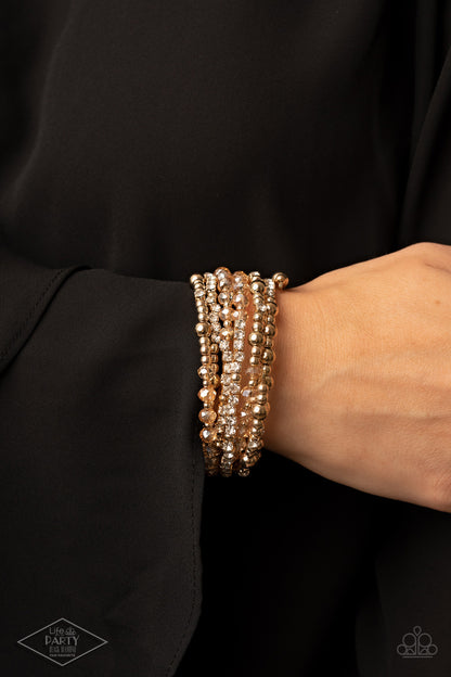 ICE Knowing You Gold Bracelet - Paparazzi Accessories  An icy collection of gold beads, gold cubes, golden crystals, and glassy white rhinestones are threaded along a coiled wire, creating a blinding infinity wrap style bracelet around the wrist.  Sold as one individual bracelet. This Fan Favorite is back in the spotlight at the request of our 2021 Life of the Party member with Black Diamond Access, Martha M.