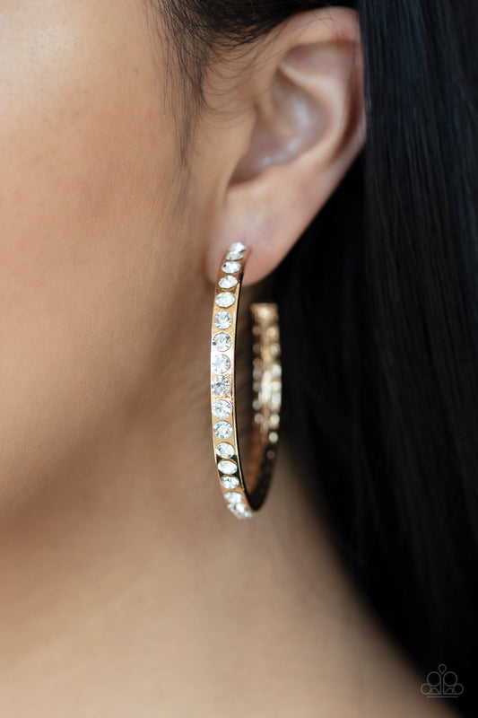 Global Gleam - Gold Item #P5HO-GDXX-135XX The outside of a delicately hammered gold hoop is encrusted in glassy white rhinestones for a blinding look. Earring attaches to a standard post fitting. Hoop measures approximately 2" in diameter.  Sold as one pair of hoop earrings.