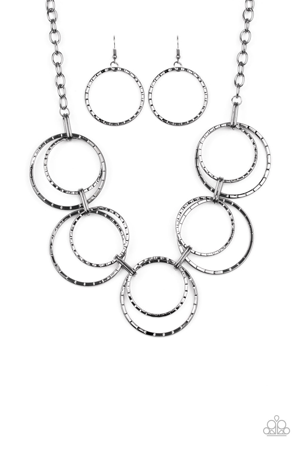 Radiant Revolution Black Necklace - Paparazzi Accessories. Etched in linear textures, pairs of oversized gunmetal hoops link below the collar for a dramatic industrial display. Features an adjustable clasp closure.  All Paparazzi Accessories are lead free and nickel free!  Sold as one individual necklace. Includes one pair of matching earrings.