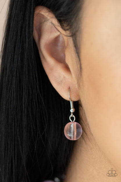 Bubbly Beauty Pink Necklace - Paparazzi Accessories  Featuring dainty silver and pink acrylic discs, a collection of oversized glassy pink beads are threaded along an invisible wire below the collar for a colorfully bubbly look. Features an adjustable clasp closure.  All Paparazzi Accessories are lead free and nickel free!  Sold as one individual necklace. Includes one pair of matching earrings.