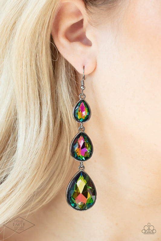 Metro Momentum Multi Earring - Paparazzi Accessories  Featuring sleek gunmetal frames, exaggerated oil spill teardrop rhinestones gradually increase in size as they drip from the ear. Earring attaches to a standard fishhook fitting.  Sold as one pair of earrings. This Fan Favorite is back in the spotlight at the request of our 2021 Life of the Party member with Black Diamond Access, Alicia W.