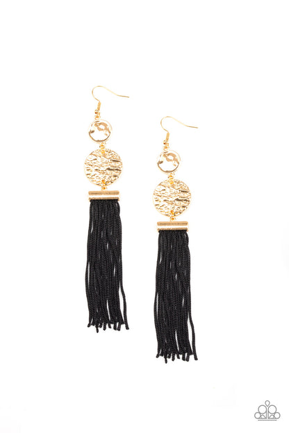Lotus Gardens Gold Tassel Earrring - Paparazzi Accessories Item #E141 A collection of black cording streams from the bottom of stacked hammered gold discs, creating a whimsical tassel. Earring attaches to a standard fishhook fitting. All Paparazzi Accessories are lead free and nickel free!  Sold as one pair of earrings.