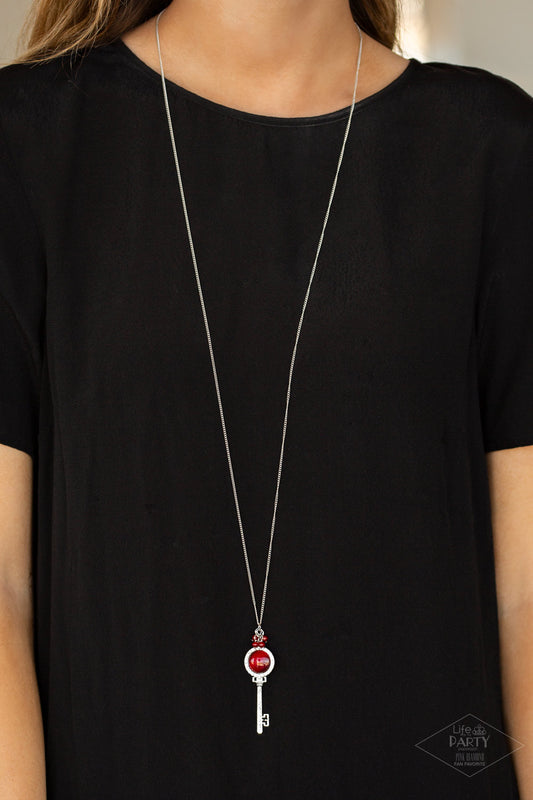 Unlock Every Door Red Necklace. A luminescent red cat's eye stone is pressed into a silver key charm, creating a colorful pendant. Infused with iridescent red cat's eye beading, the silver key is encrusted in glittery white rhinestones for a dazzling finish. Features an adjustable clasp closure. All Paparazzi Accessories are lead free and nickel free! Includes one pair of matching earrings.  This Fan Favorite is back in the spotlight in an all new color.