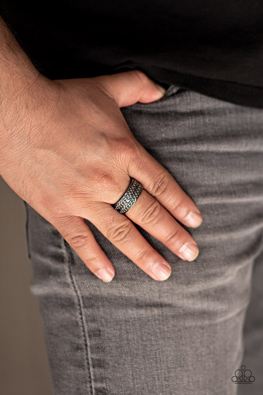Man vs. Machine Black Unisex Ring - Paparazzi Accessories  Rows of chain-like texture are embossed across the front of a glistening gunmetal band for a bold industrial look. Features a stretchy band for a flexible fit.  Sold as one individual ring.