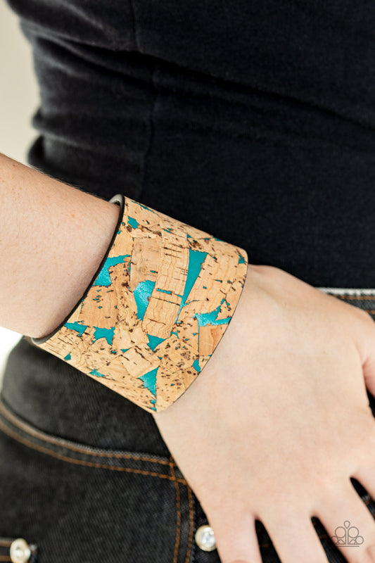 Cork Congo Blue Wrap Bracelet - Paparazzi Accessories Pieces of cork have been plastered across the front of a blue leather band, creating an earthy look around the wrist. Features an adjustable snap closure. Sold as one individual bracelet.