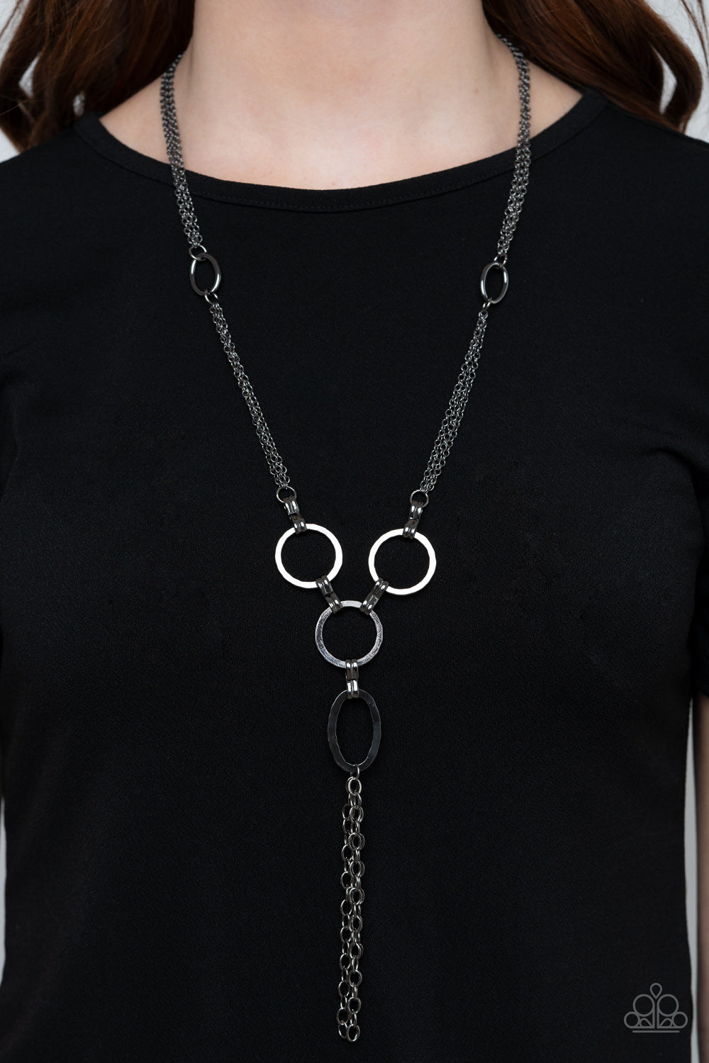 Metro Mechanics Black Necklace - Paparazzi Accessories. Hammered gunmetal rings and ovals link into an industrial style pendant at the bottom of shimmery sections of gunmetal chains. Classic gunmetal chains stream from the bottom of the display, adding edgy movement. Features an adjustable clasp closure.  All Paparazzi Accessories are lead free and nickel free!  Sold as one individual necklace. Includes one pair of matching earrings.
