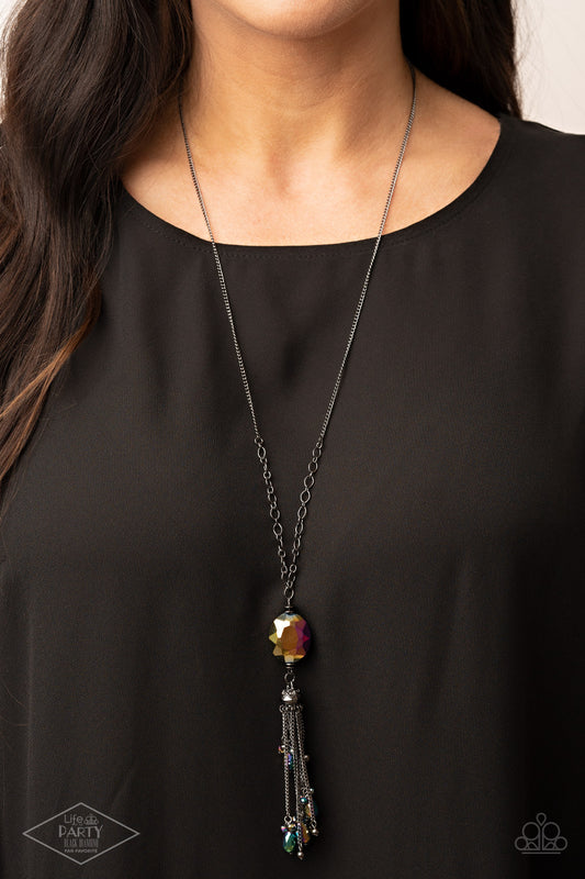 Fringe Flavor Multi Necklace - Paparazzi Accessories  Featuring an oil spill finish, a faceted oil spill gem attaches to the bottom of a lengthened gunmetal chain featuring sections of airy chain links. Infused with dainty gunmetal and matching oil spill beads, shimmery gunmetal chains stream from the bottom of a hematite dotted cap, creating an edgy tassel. This Fan Favorite is back in the spotlight at the request of our 2021 LOP member with Black Diamond Access, Danielle B.