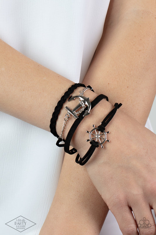 Anchors Away Black Bracelet - Paparazzi Accessories  Braided black leather and a strand of silver studs are complemented by black suede in a boyfriend bracelet style. Gorgeous nautical elements in a classic silver finish add undeniable charm. Features an adjustable clasp closure.  Sold as one individual bracelet. This Fan Favorite is back in the spotlight at the request of our 2021 Life of the Party member with Black Diamond Access, LeCricia S.