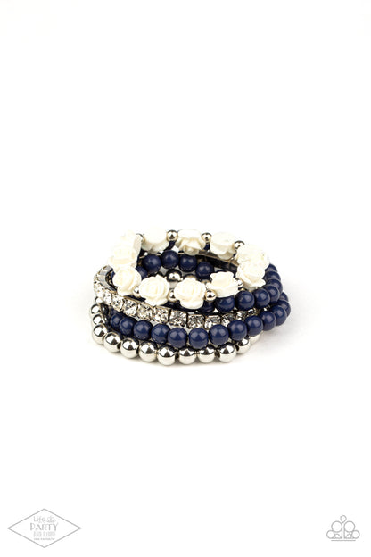 Rose Garden Grandeur Blue Bracelet - Paparazzi Accessories  A vintage inspired collection of ivory resin roses, navy beads, and classic silver beads join a stretchy band of glittery white rhinestones dotted around the wrist for a flawlessly stacked look.  Sold as one set of five bracelets. This Fan Favorite is back in the spotlight at the request of our 2021 Life of the Party member with Black Diamond Access, Andrea H.
