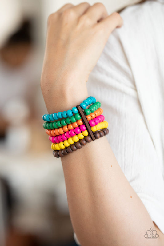 Diving in Maldives Multi Wooden Bracelet - Paparazzi Accessories.  Held in place with rectangular wooden fittings, a collection of vivacious pink, blue, orange, green, yellow, and brown wooden beads are threaded along stretchy bands around the wrist, creating colorful layers.  ﻿﻿﻿All Paparazzi Accessories are lead free and nickel free!  Sold as one individual bracelet.