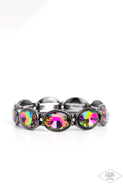 Diva In Disguise Multi Stretch Bracelet - Paparazzi Accessories  Glittery oil spill gems are pressed into sleek gunmetal frames. Infused with dainty gunmetal beads, the sparkly frames are threaded along stretchy bands for a glamorous look around the wrist.  Sold as one individual bracelet.  P9RE-MTXX-069XX