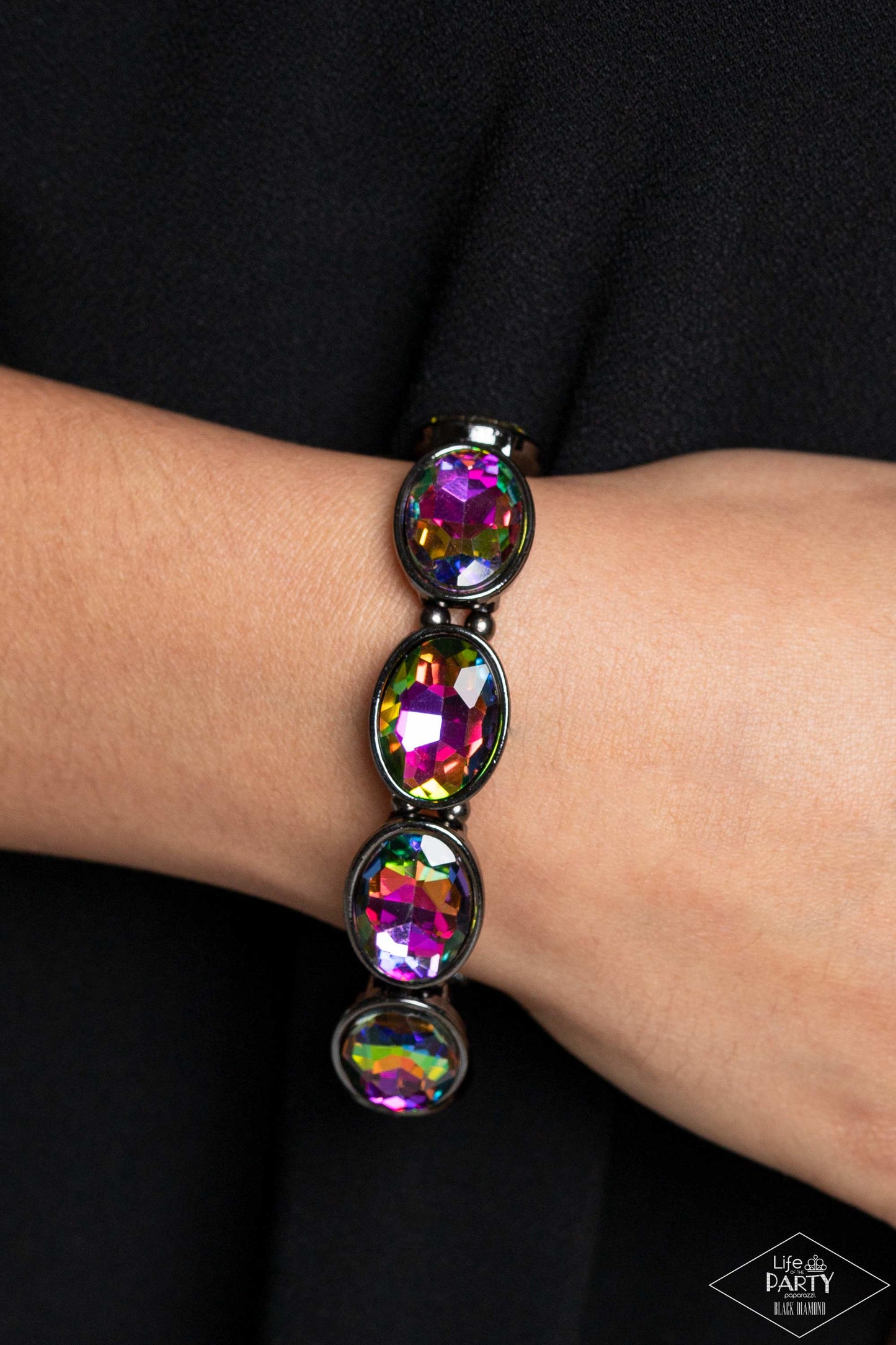 Diva In Disguise Multi Stretch Bracelet - Paparazzi Accessories  Glittery oil spill gems are pressed into sleek gunmetal frames. Infused with dainty gunmetal beads, the sparkly frames are threaded along stretchy bands for a glamorous look around the wrist.  Sold as one individual bracelet.  P9RE-MTXX-069XX