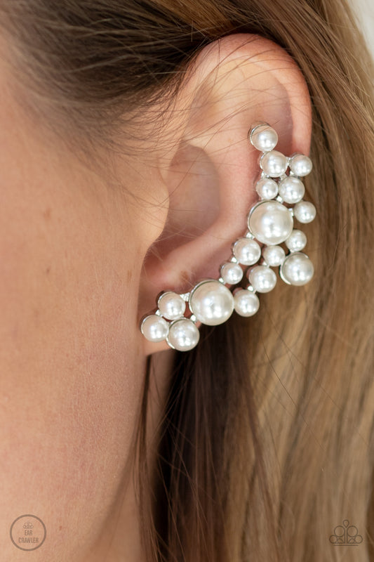 Metro Makeover White Ear Crawler Earring - Paparazzi Accessories  A collection of bubbly white pearls dot a shiny silver frame that branches up the ear for a modern, timeless twist. Earring attaches to a standard post fitting. Features a clip-on fitting at the top for a secure fit.  ﻿All Paparazzi Accessories are lead free and nickel free!  Sold as one pair of ear crawlers.