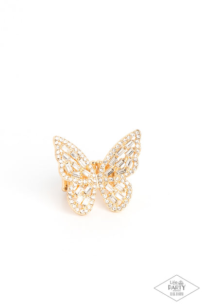 Flauntable Flutter Gold Butterfly Ring - Paparazzi Accessories Item #P4RE-GDXX-218XX Dainty white emerald cut rhinestones are sprinkled across the golden wings of a butterfly that is encrusted in glassy white rhinestones for a dramatically dazzling finish. Features a stretchy band for a flexible fit.  Sold as one individual ring. This Black Diamond Encore is back in the spotlight at the request of our 2022 Life of the Party member with Black Diamond Access, Karla N.