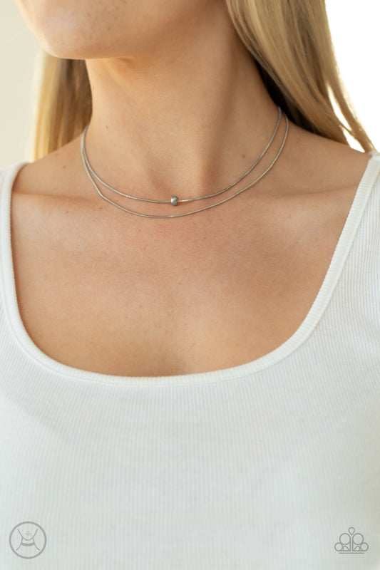 Super Slim Silver Choker Necklace - Paparazzi Accessories  Infused with a single silver bead, two dainty rows of rounded snake chain layer around the neck for a seamlessly chic look. Features an adjustable clasp closure.  All Paparazzi Accessories are lead free and nickel free!  Sold as one individual choker necklace. Includes one pair of matching earrings.