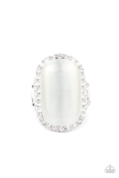 Thank Your LUXE-y Stars White Ring - Paparazzi Accessories  An oversized white cat's eye stone sits atop an icy silver frame bedazzled in blinding white rhinestones for a luxurious look. Features a stretchy band for a flexible fit.  All Paparazzi Accessories are lead free and nickel free!  Sold as one individual ring.