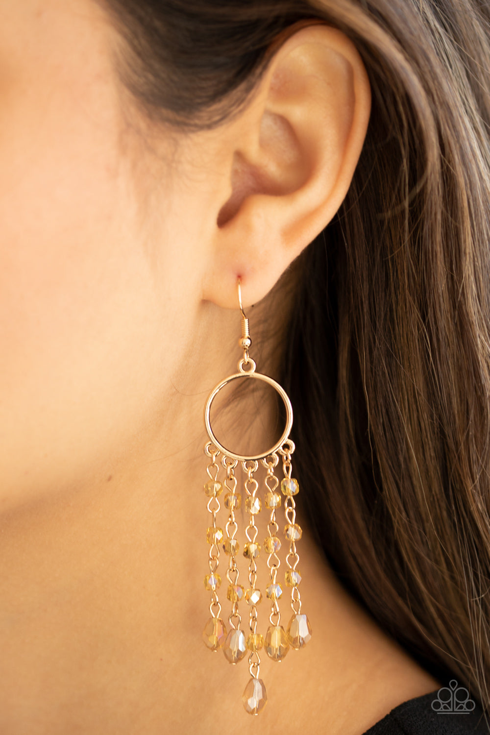 Dazzling Delicious Gold Earring - Paparazzi Accessories  Glittery rows of iridescently golden crystal-like beads stream from the bottom of a dainty gold hoop, creating a dazzling chandelier. Earring attaches to a standard fishhook fitting.  ﻿All Paparazzi Accessories are lead free and nickel free!  Sold as one pair of earrings.