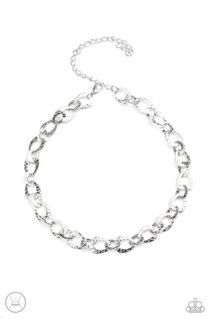 Urban Safari Silver Choker Necklace - Paparazzi Accessories.  Embossed in a metallic crocodile-like print, asymmetrical silver links delicately connect around the neck for a wild industrial inspired look. Features an adjustable clasp closure.  ﻿﻿﻿All Paparazzi Accessories are lead free and nickel free!  Sold as one individual choker necklace. Includes one pair of matching earrings.