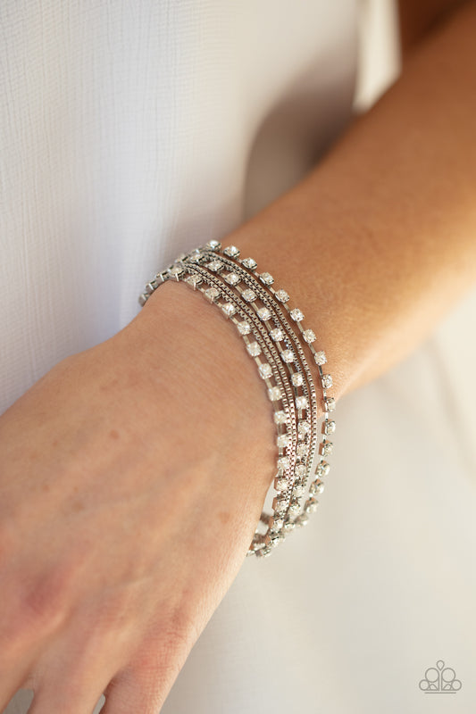 Thats a Smash! White Bracelet - Paparazzi Accessories  Strands of glittery white rhinestones and rows of dainty silver box chains alternate across the wrist, layering into a sassy display of sparkle. Features an adjustable clasp closure.  ﻿All Paparazzi Accessories are lead free and nickel free!  Sold as one individual bracelet.