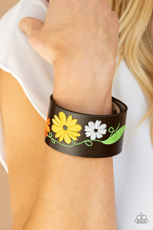 Western Eden Yellow Wrap Bracelet - Paparazzi Accessories  A colorful floral pattern is embroidered across the front of a black leather band, creating a whimsical centerpiece around the wrist. Features an adjustable snap closure.  All Paparazzi Accessories are lead free and nickel free!  Sold as one individual bracelet.