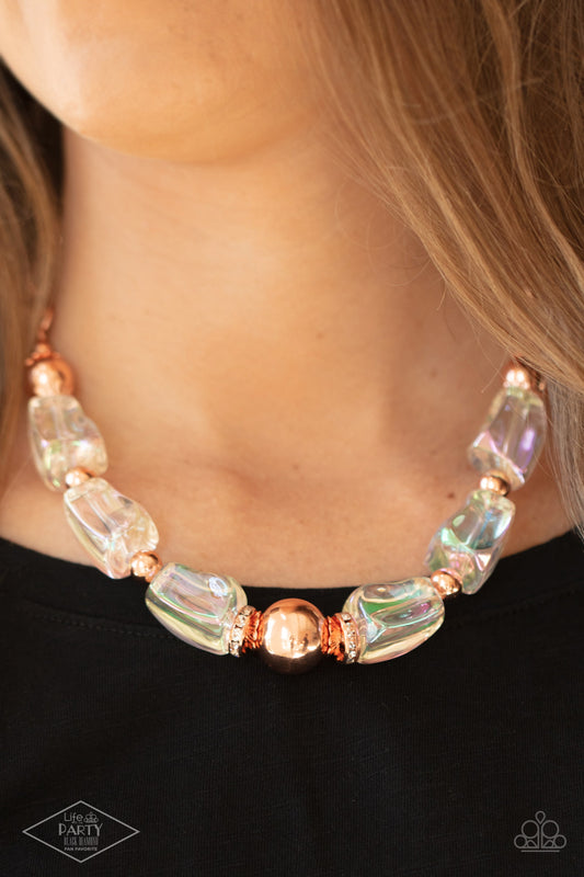 Iridescently Ice Queen Copper Necklace - Paparazzi Accessories  Featuring an icy iridescence, glassy asymmetrical beads join a mismatched collection of shiny copper beads, white rhinestone encrusted rings, and scalloped shiny copper accents below the collar. Attached to a shiny copper chain, the glacial display catches and reflects light for a statement-making finish. Features an adjustable clasp closure.  Sold as one individual necklace. Includes one pair of matching earrings.
