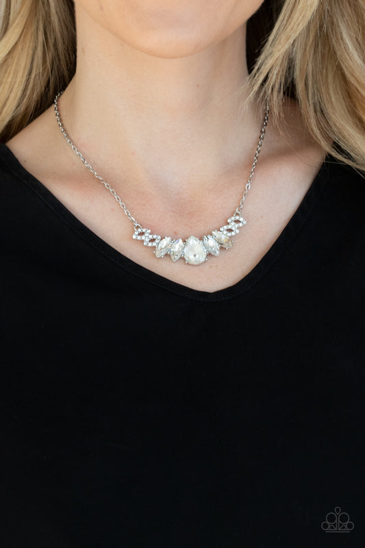 Bride-to-BEAM White Necklace - Paparazzi Accessories  Featuring a dramatically oversized white teardrop rhinestone center, dainty white rhinestone encrusted silver frames connect with pairs of glassy marquise cut rhinestones below the collar for a sparkly statement-making look. Features an adjustable clasp closure.  ﻿All Paparazzi Accessories are lead free and nickel free!  Sold as one individual necklace. Includes one pair of matching earrings.