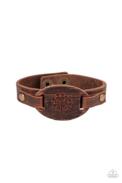 All Fine and DANDELION Brown Urban Bracelet - Paparazzi Accessories  Stamped in a rustic dandelion decoration, a piece of brown leather is studded in place across the front of a distressed leather band for a whimsically southern look. Features an adjustable sliding knot closure.  ﻿All Paparazzi Accessories are lead free and nickel free!  Sold as one individual bracelet.
