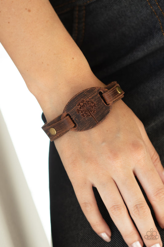 All Fine and DANDELION Brown Urban Bracelet - Paparazzi Accessories  Stamped in a rustic dandelion decoration, a piece of brown leather is studded in place across the front of a distressed leather band for a whimsically southern look. Features an adjustable sliding knot closure.  ﻿All Paparazzi Accessories are lead free and nickel free!  Sold as one individual bracelet.