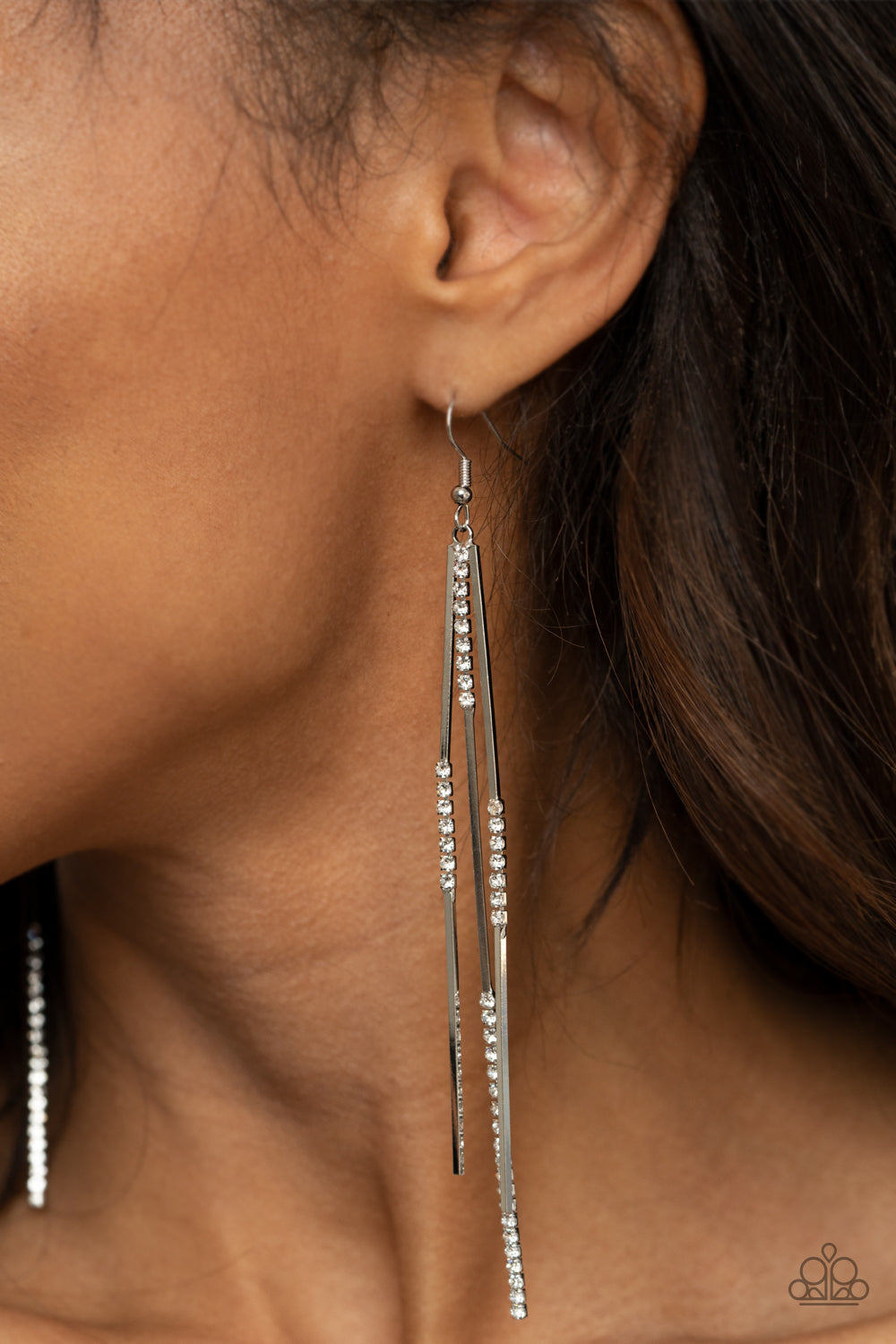 Dainty Dynamism White Earring - Paparazzi Accessories  Sections of glassy white rhinestones attach to dainty silver rectangular rods, creating a statement-making tassel. Earring attaches to a standard fishhook fitting.  ﻿All Paparazzi Accessories are lead free and nickel free!  Sold as one pair of earrings.