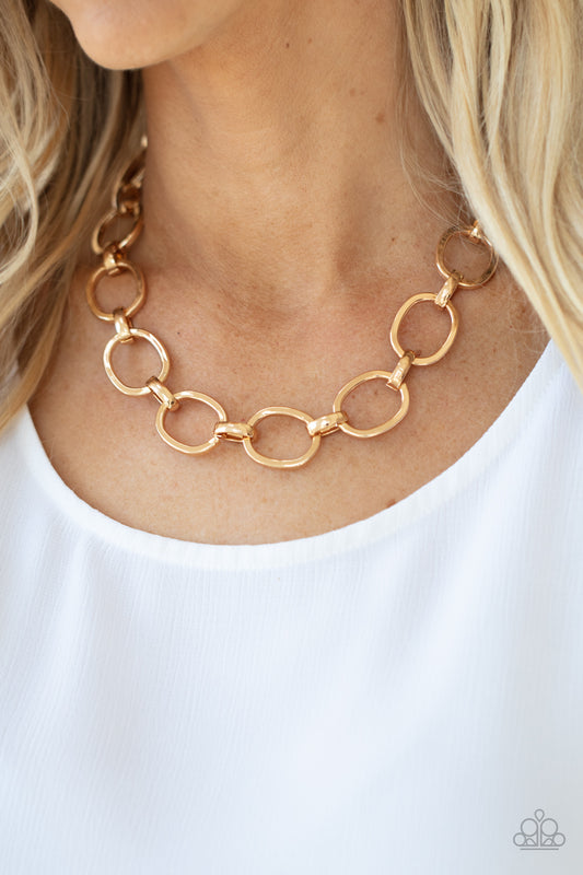 HAUTE-ly Contested Gold Necklace - Paparazzi Accessories  A glistening series of dramatically oversized ovals and links boldly connect below the collar, creating an intense industrial statement. Features an adjustable clasp closure.  All Paparazzi Accessories are lead free and nickel free!  Sold as one individual necklace. Includes one pair of matching earrings.
