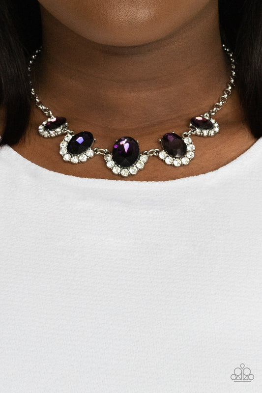 The Queen Demands It Purple Necklace - Paparazzi Accessories  Gradually increasing in size at the center, the sparkly bottoms of oversized purple gems are bordered in rows of glassy white rhinestones as they link below the collar for a dramatic effect. Features an adjustable clasp closure.  All Paparazzi Accessories are lead free and nickel free!  Sold as one individual necklace. Includes one pair of matching earrings.