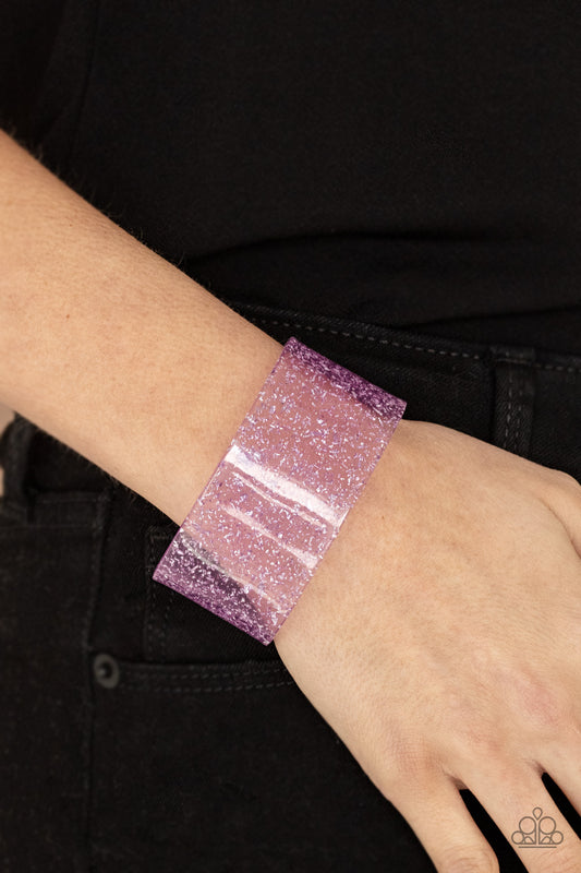 Snap, Crackle, Pop! Purple Cuff Bracelet - Paparazzi Accessories. Dainty silvery shavings are encased in a thick purple acrylic cuff, creating an icy incandescence around the wrist.  Sold as one individual bracelet.