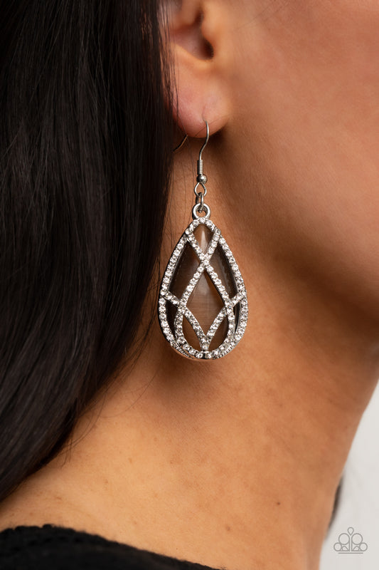Crawling With Couture Brown Earring - Paparazzi Accessories  White rhinestone encrusted silver bars crisscross into a glittering beveled teardrop that delicately overlaps an oversized brown teardrop cat's eye stone, creating a luminously layered lure. Earring attaches to a standard fishhook fitting.  All Paparazzi Accessories are lead free and nickel free!  Sold as one pair of earrings.