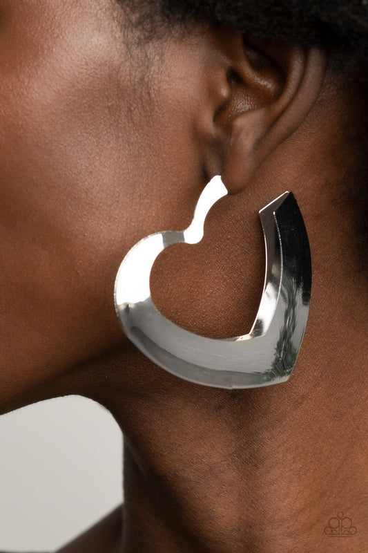 Heart-Racing Radiance Silver Hoop Earring - Paparazzi Accessories  Flat silver frames delicately collect into a voluminous heart shaped hoop for a flirtatious display. Earring attaches to a standard post fitting. Hoop measures approximately 2 1/4" in diameter.  All Paparazzi Accessories are lead free and nickel free!  Sold as one pair of hoop earrings.